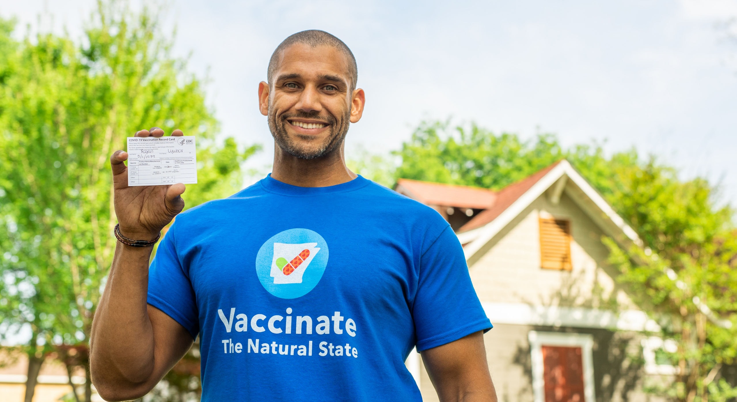 Man holding vaccination card